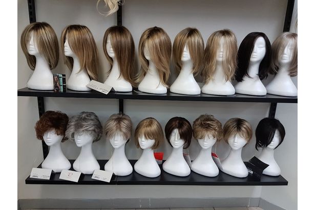 Premium display of wigs on a mannequin head.